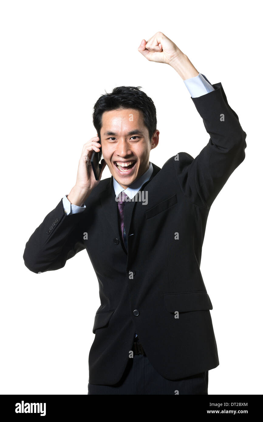 Portrait of a successful Chinese businessman celebrating. Isolated on a white background. Stock Photo