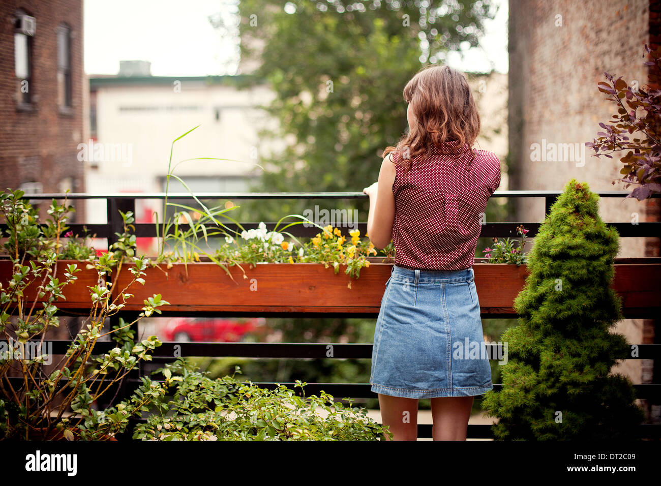 Rear view of young woman wearing denim skirt Stock Photo