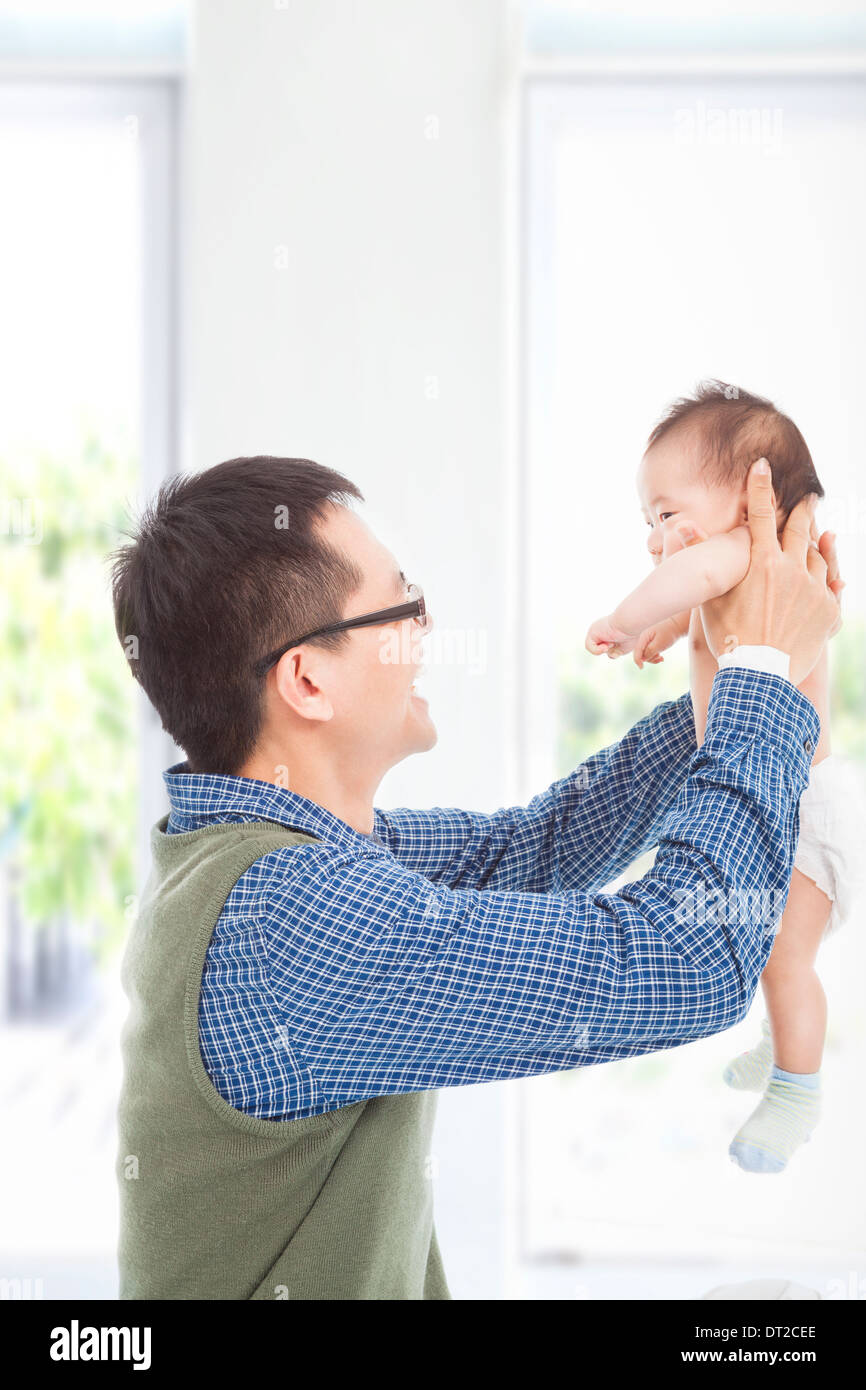 Happy father hug his smiling son at home Stock Photo