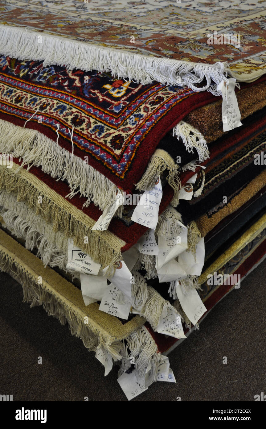 Oriental rugs, mostly handmade, from around the world, stacked up in a