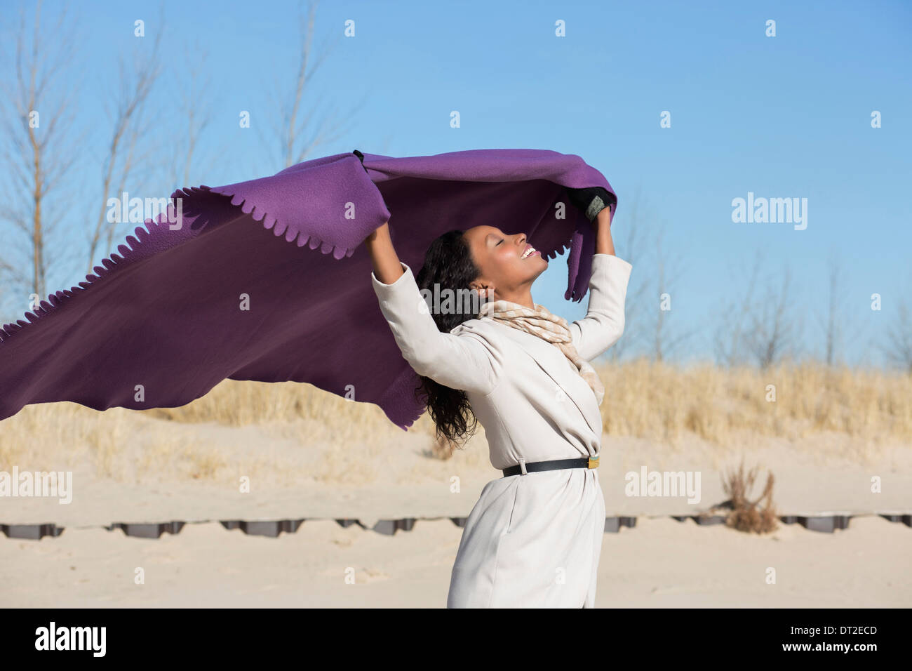 USA, Illinois, Waukegan, Young woman holding blanket above her head Stock Photo