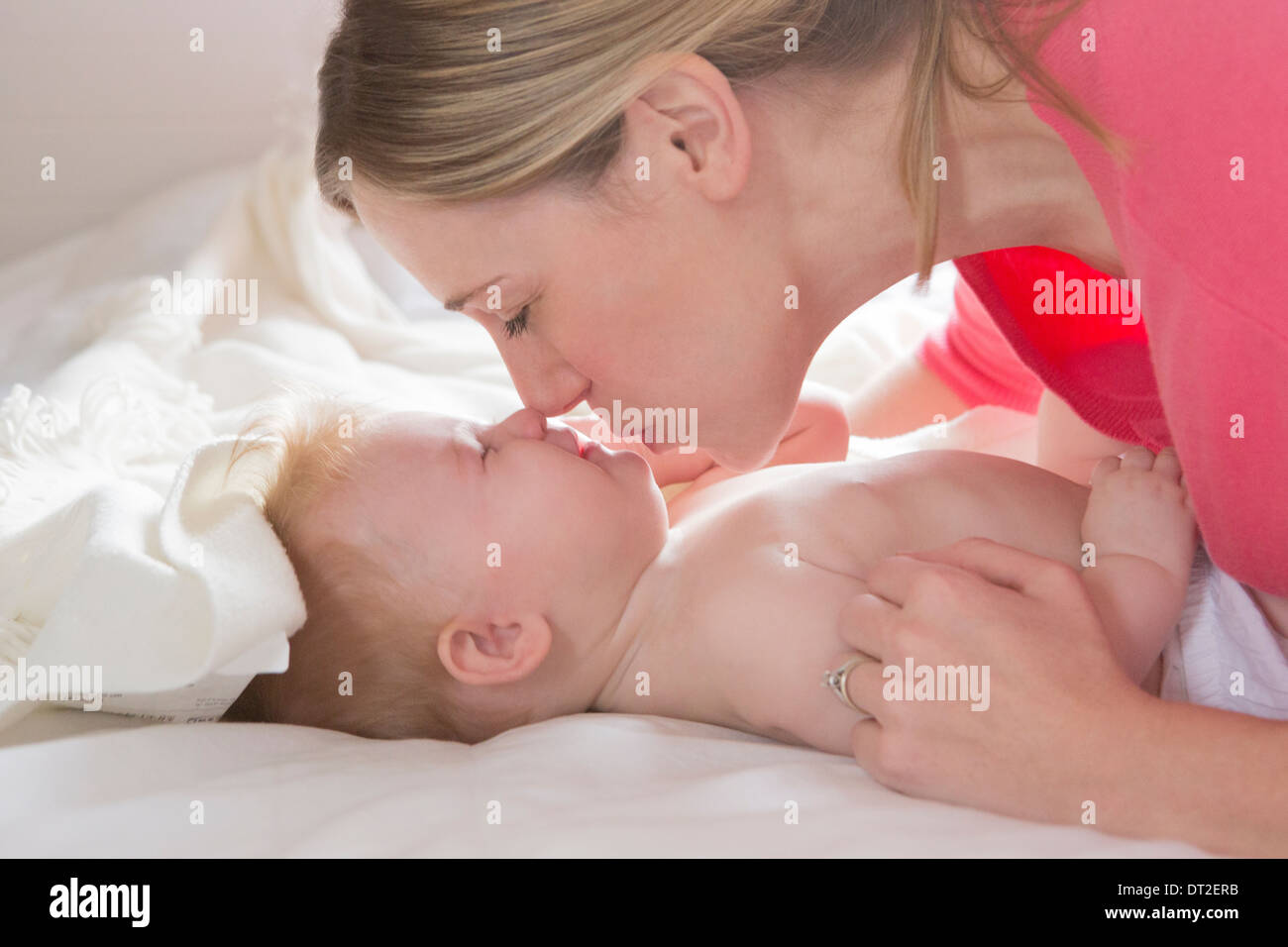 Mother kissing her baby daughter (6-11 months) Stock Photo