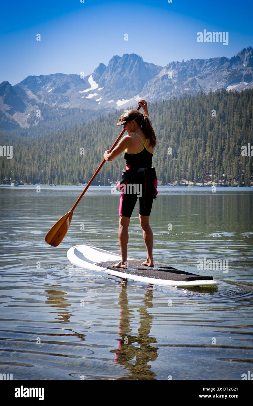 USA, California, High Sierra's, Lake Mary, Woman on stand up paddle board Stock Photo