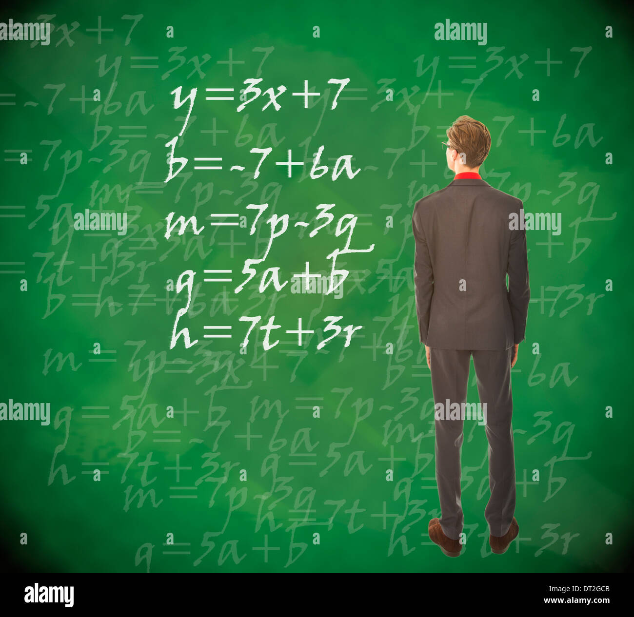 Young student looking at chalkboard with mathematics Stock Photo