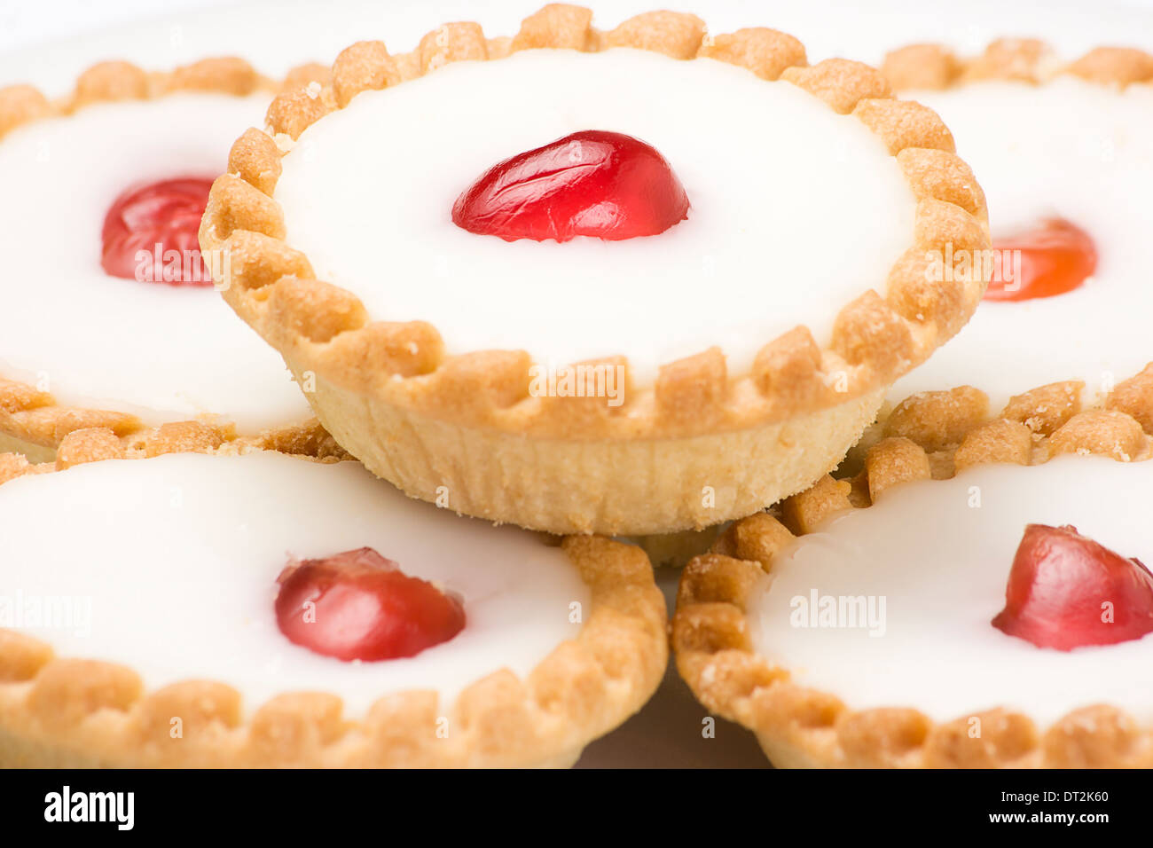 cherry tart cakes close up with fondant topping and a candid cherry in the middle The Bakewell Tart is an English confection Stock Photo