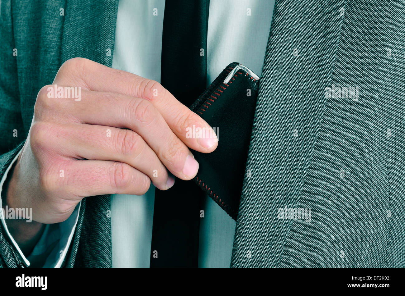 man wearing a suit taking out his wallet from his jacket Stock Photo