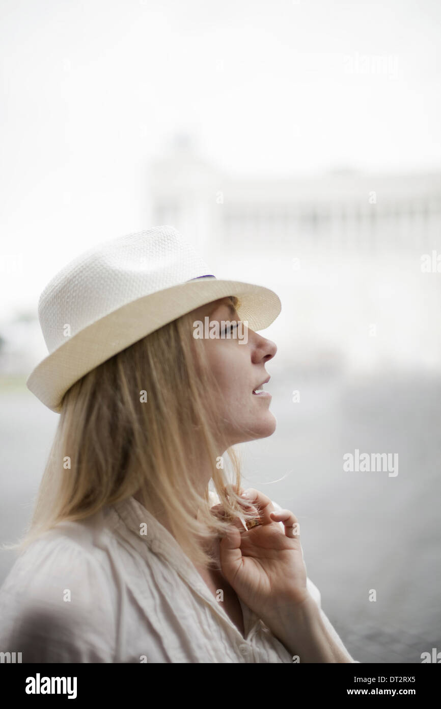 A woman with blonde hair wearing a cream panama hat Stock Photo