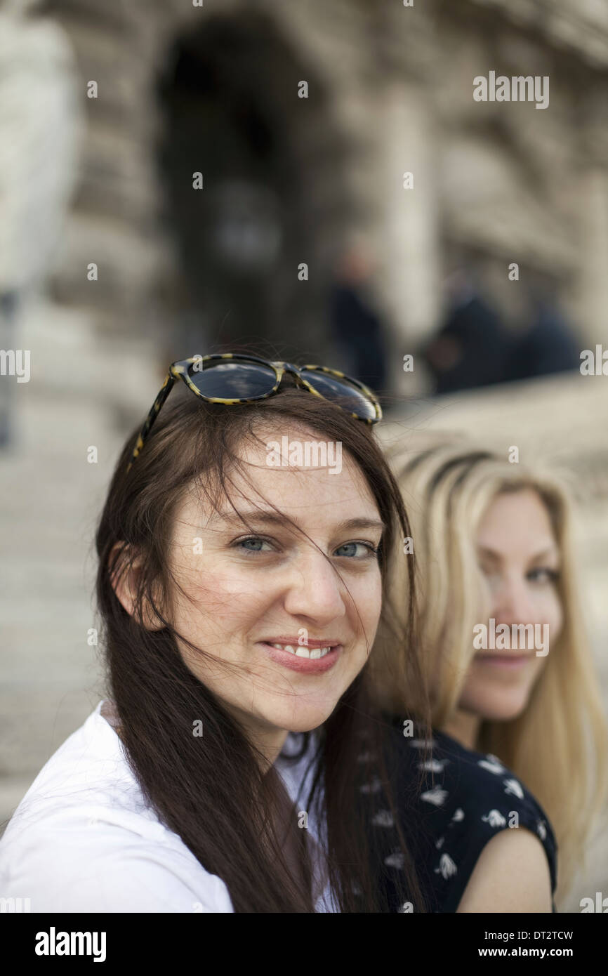 Two women in the street in the historic city of Rome A blonde haired