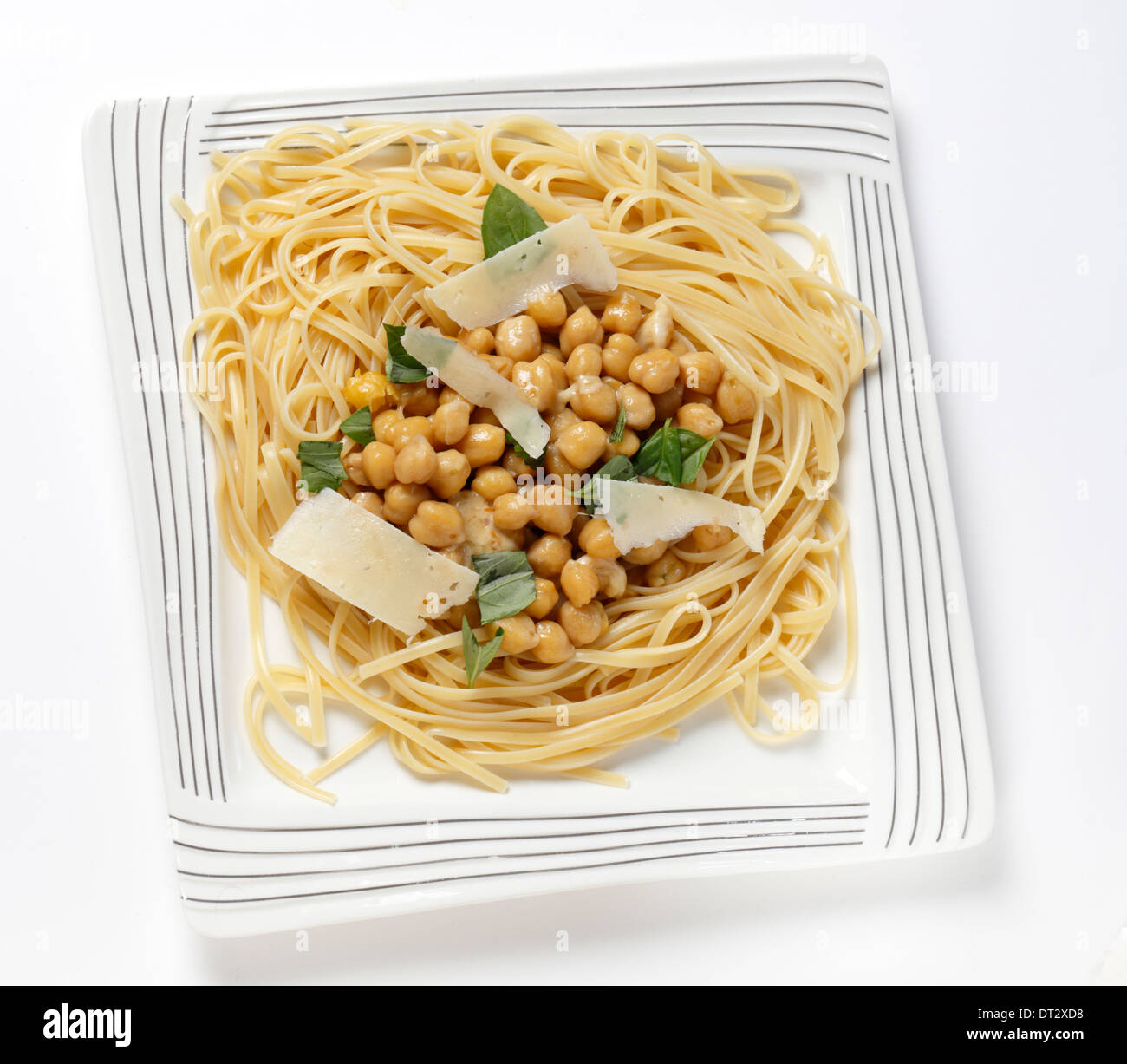 Bavette pasta (like linguine)  with a chickpea, garlic, chili and parmesan sauce, and garnished with torn basil leaves Stock Photo