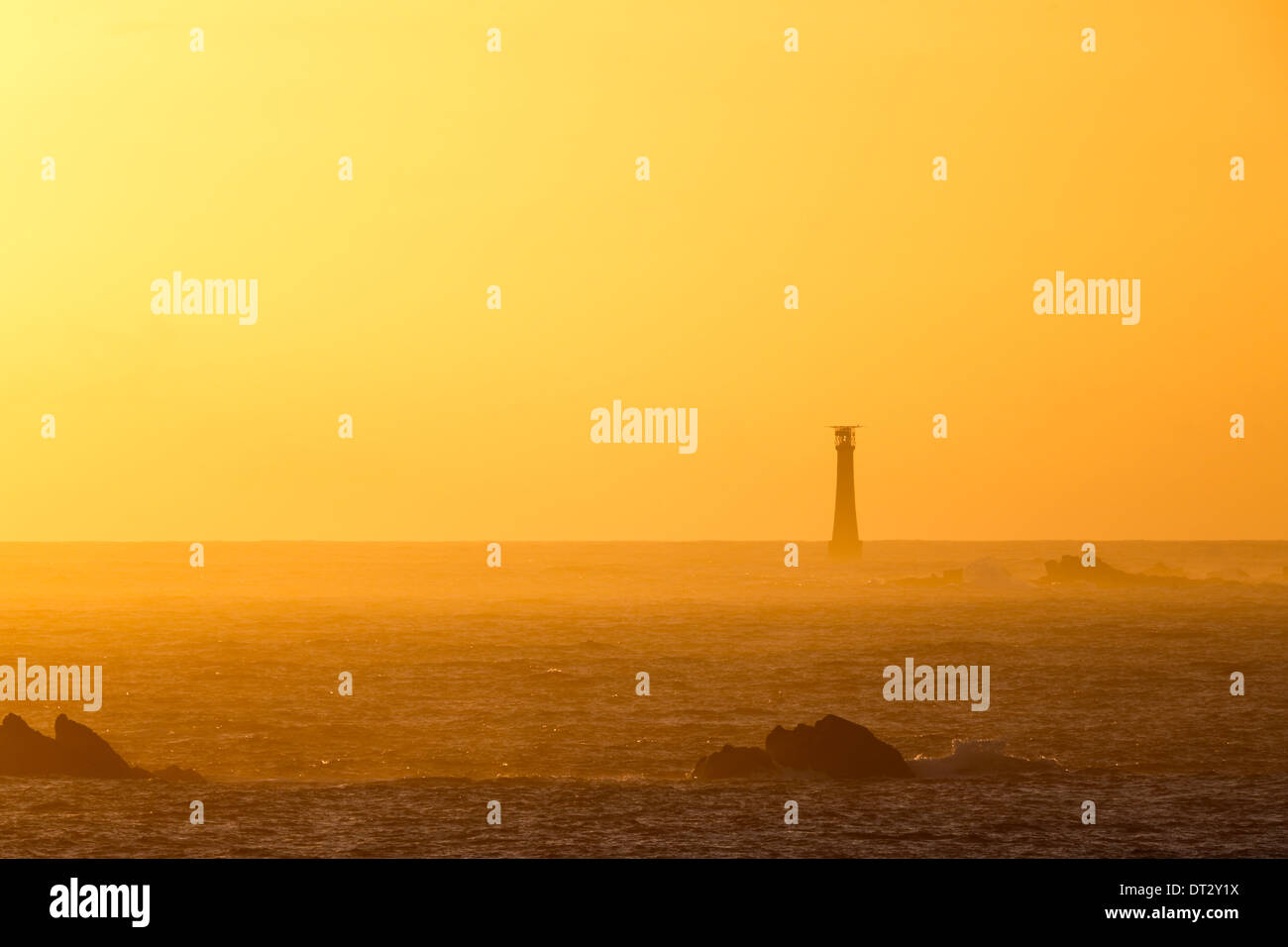 looking WSW from St Agnes towards the Bishop Rock Lighthouse on the Isles of Scilly at sunset Stock Photo