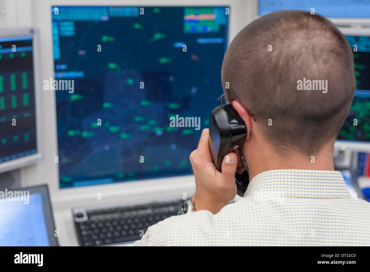 An air traffic controller in the air traffic control centre of 'Skyguide' is navigating aircrafts through Switzerland's airspace Stock Photo