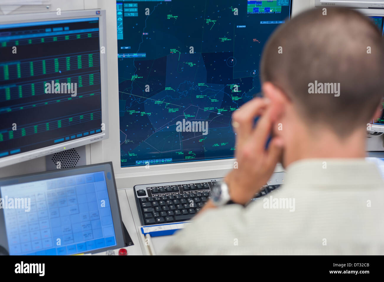 An air traffic controller in the air traffic control centre of 'Skyguide' is navigating aircrafts through Switzerland's airspace Stock Photo