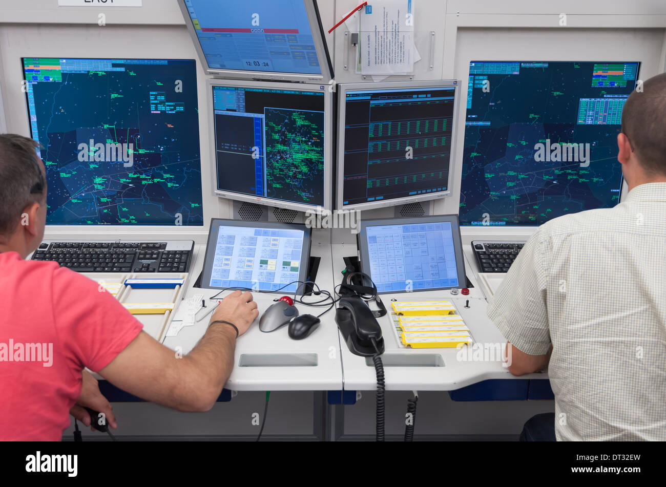 Two air traffic controllers in the air traffic control centre of 'Skyguide' are navigating aircrafts through Switzerland's air Stock Photo