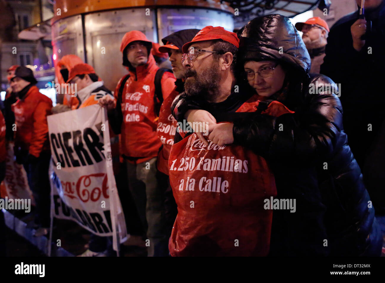 Madrid, Spain. 6th Feb, 2014. 56 year-old Francisco IÃƒÂ±igo who has been working 32 years in maintenance at coca-cola's factory is embraced by her 55 year old wife Aurora Jurado, during a demonstration against the soft drink manufacturer in Madrid, Spain, Thursday, Feb. 6, 2014. Coca-Cola's workers are on an indefinite strike protesting Coca-Cola Iberian Partners' plans to close four of its 11 plants and lay off some 1,253 workers. Credit:  Rodrigo Garcia/NurPhoto/ZUMAPRESS.com/Alamy Live News Stock Photo