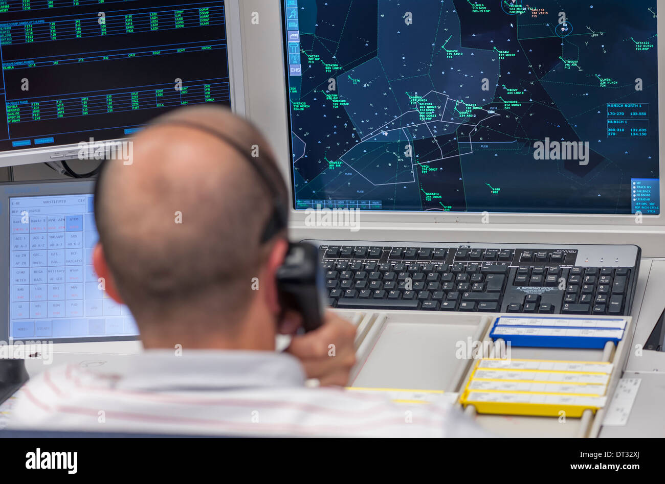 An air traffic controller in the air traffic control centre of 'Skyguide' is navigating aircrafts through Switzerland's airspace Stock Photo