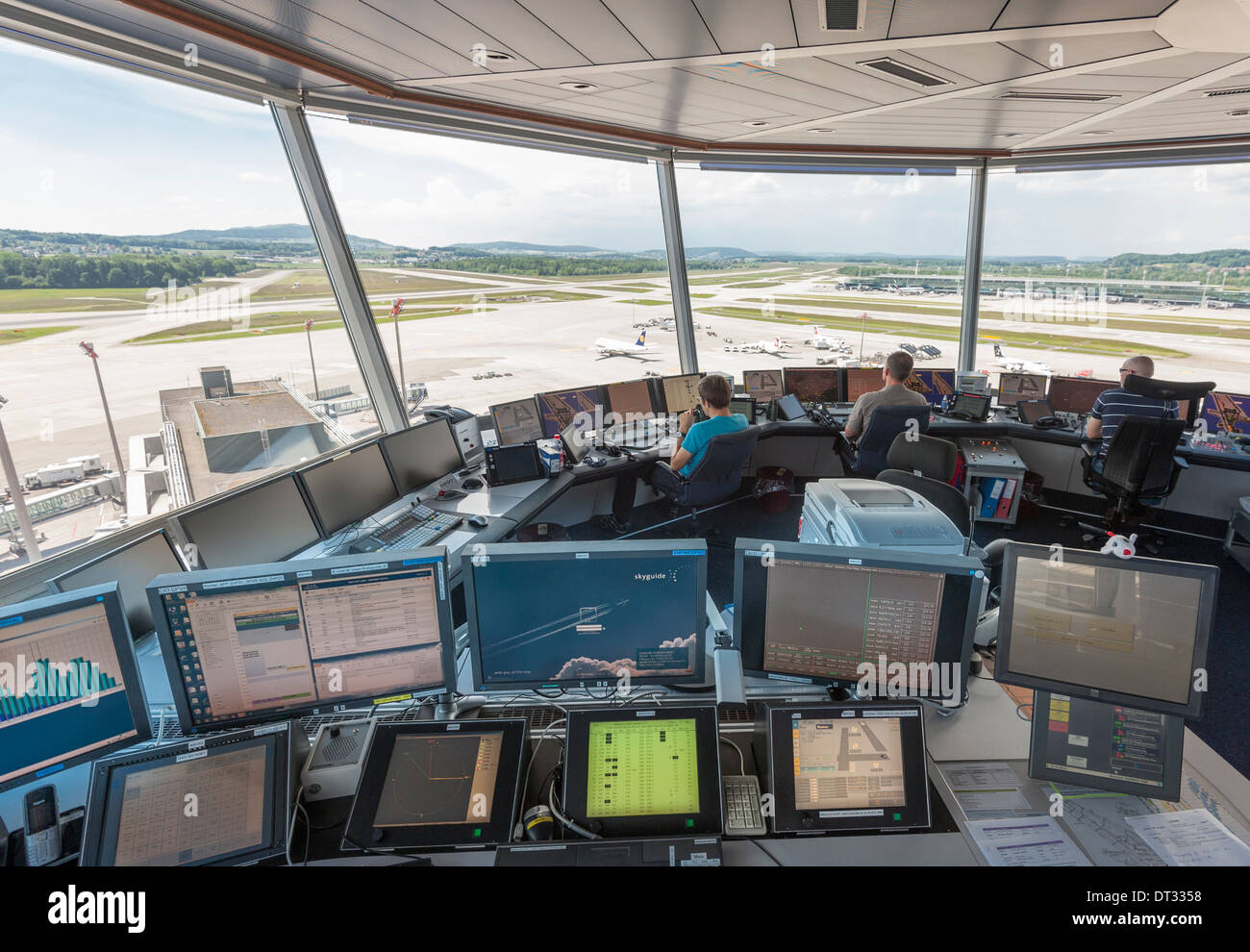 Air traffic controllers in the control tower of Zurich/Kloten international airport are monitoring the airport's airfield. Stock Photo