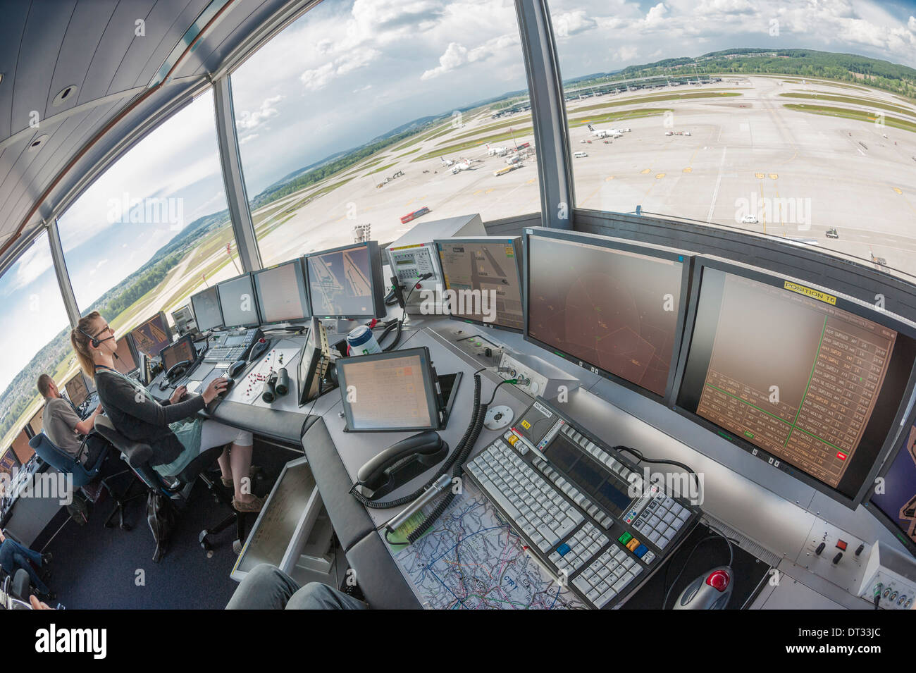 Air traffic controllers in the control tower of Zurich/Kloten international airport are monitoring the airport's airfield. Stock Photo