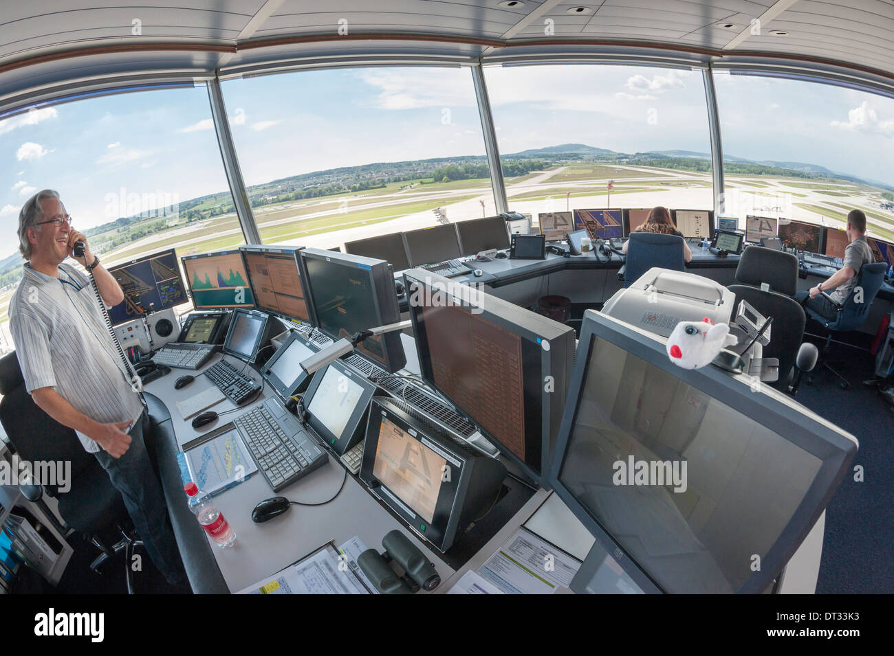 Air traffic controllers in the control tower of Zurich/Kloten international airport are monitoring the airport's airfield. Stock Photo