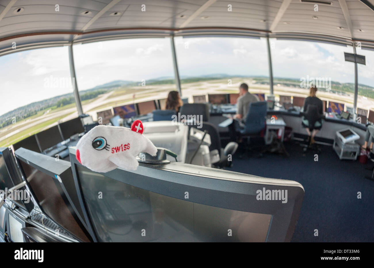 Air traffic controllers in the control tower of Zurich/Kloten international airport are monitoring the airport's airfield. Stock Photo