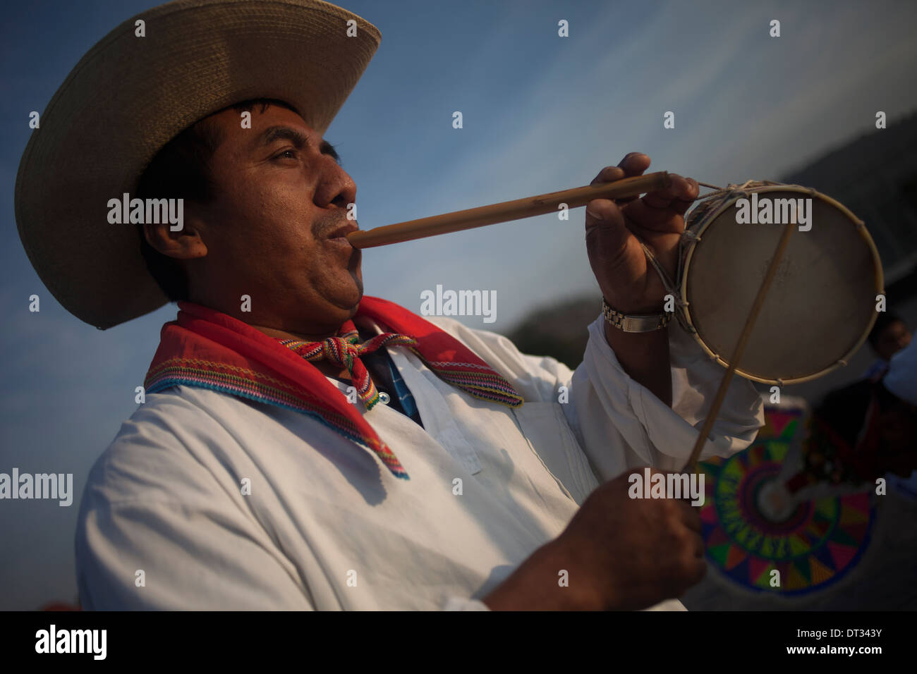 A Totonacan indigenous man plays flute and drums at the pilgrimage to Our Lady of Guadalupe Basilica in Mexico Stock Photo