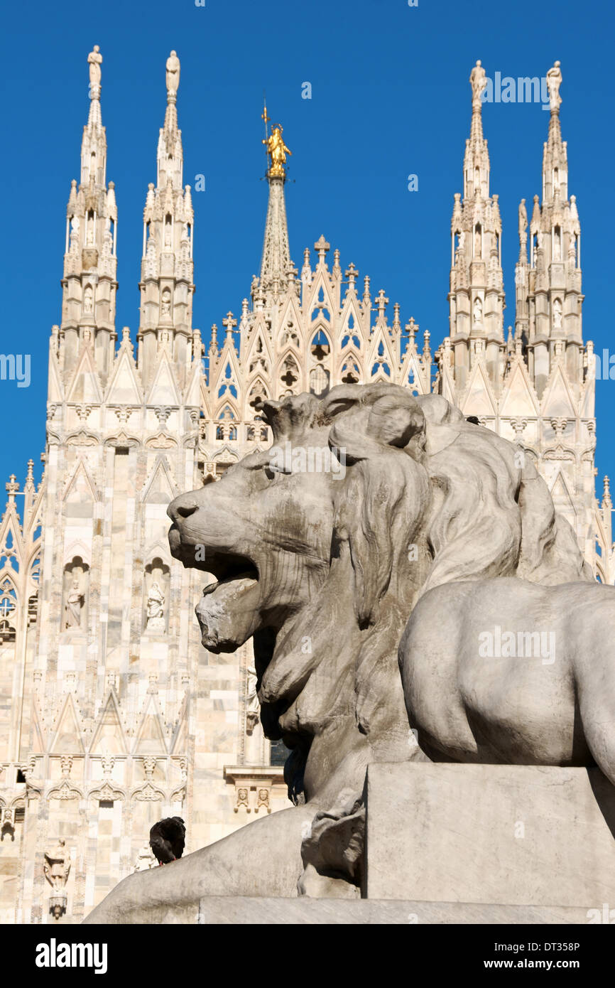 Piazza del Duomo in Milan, Italy. Detail of lion statue and Duomo di Milano (Milan Cathedral) in the background. Stock Photo