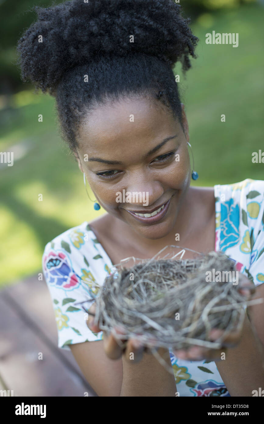 A woman holding a bird nest in her hands Stock Photo