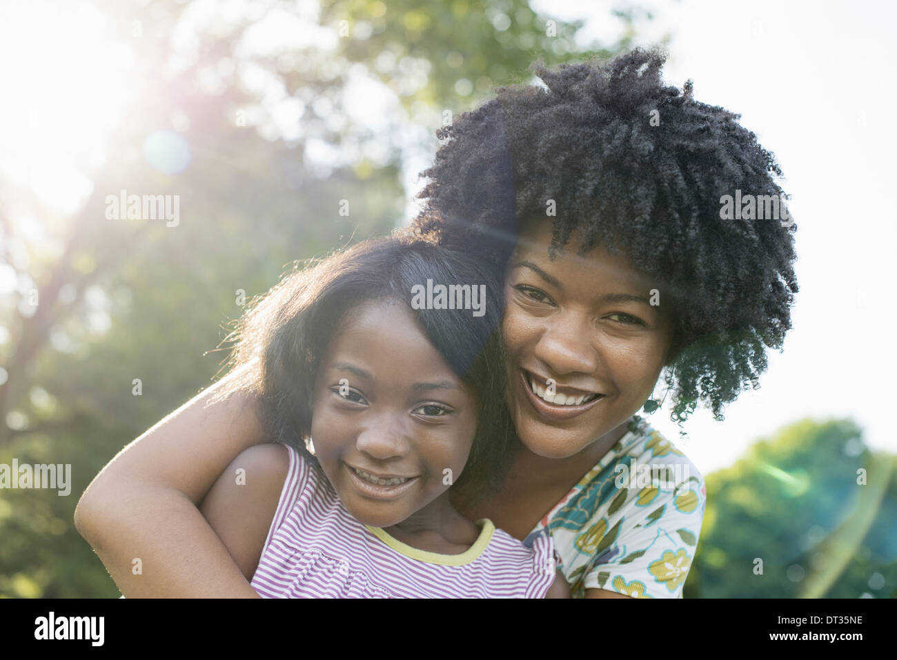 A young woman and a child hugging Stock Photo