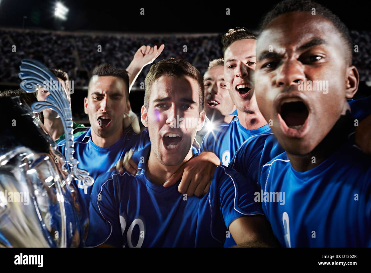 Soccer team cheering on field Stock Photo