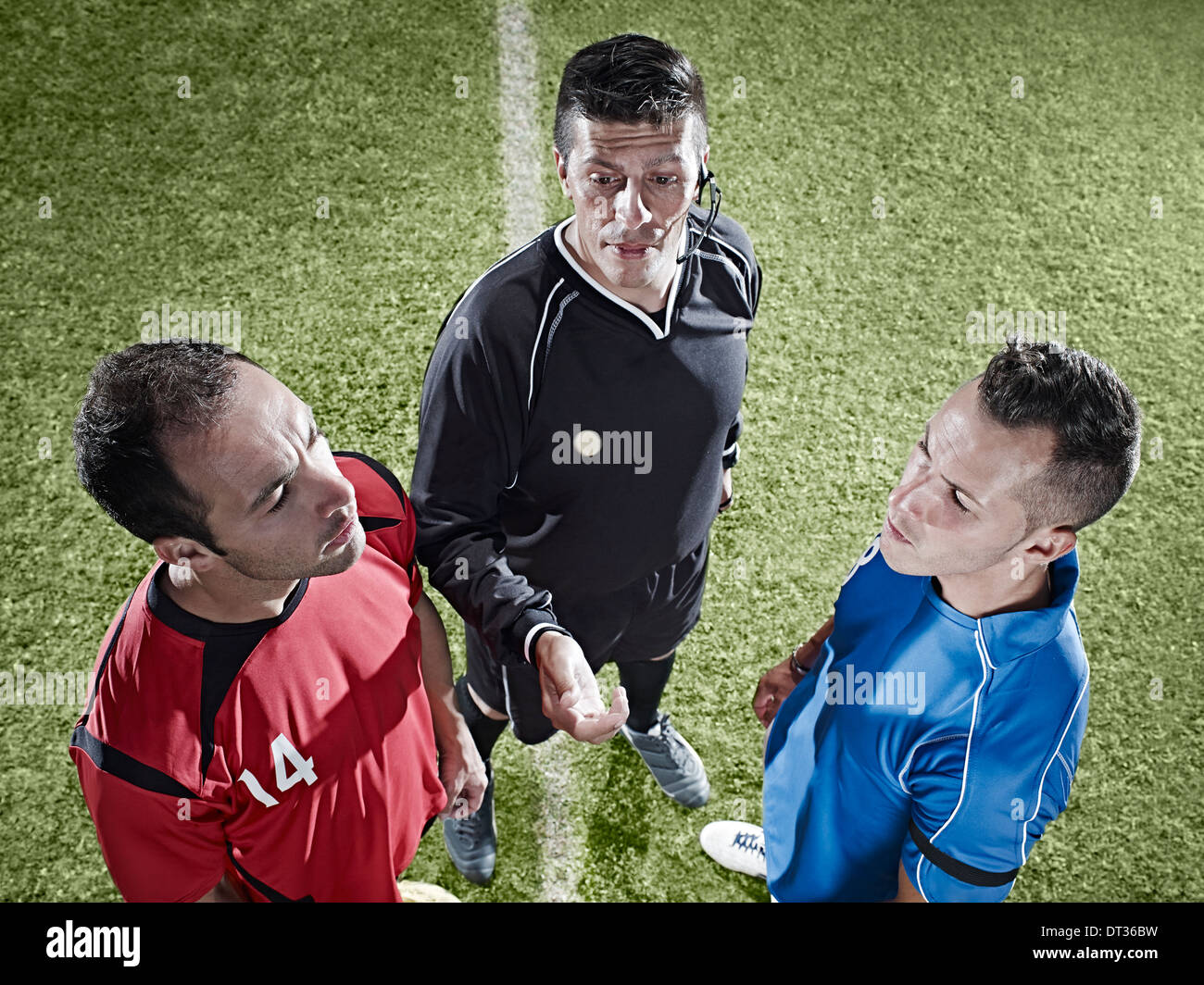 Soccer players facing each other on field Stock Photo