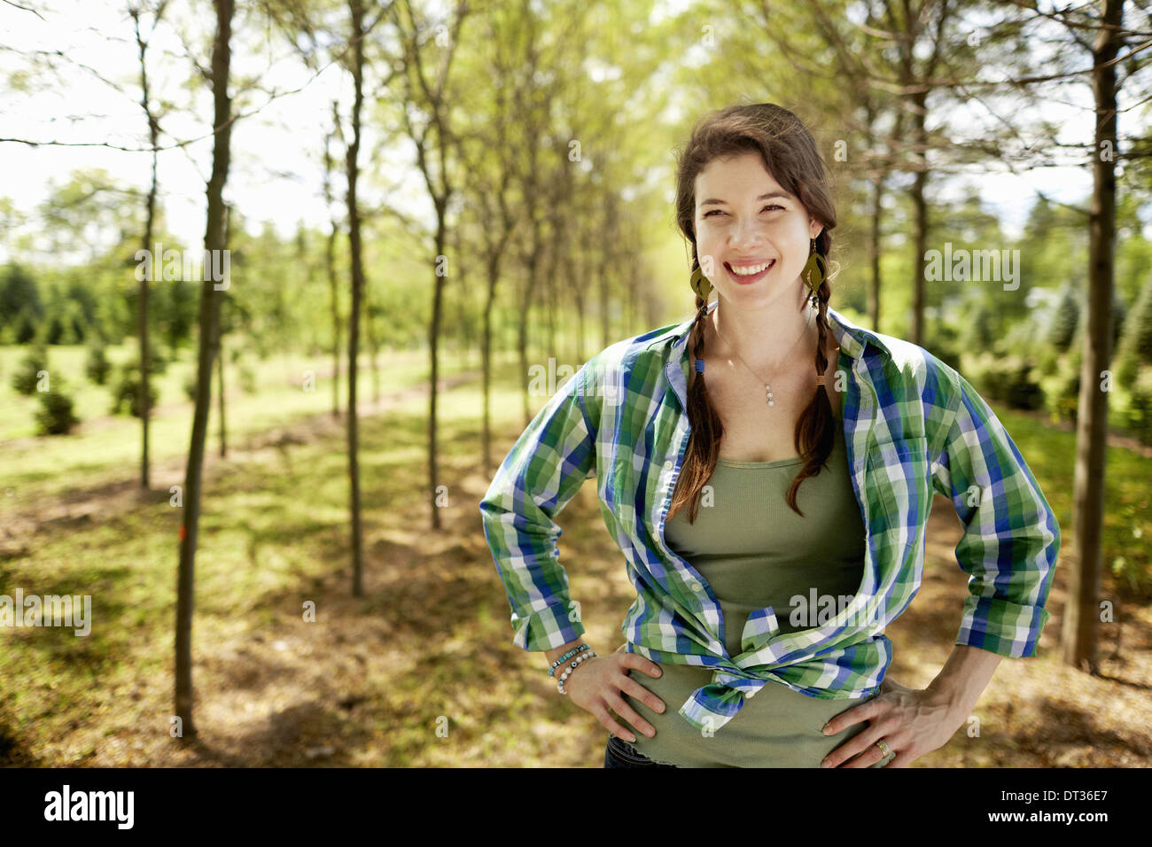A girl in a green checked shirt with braids Stock Photo