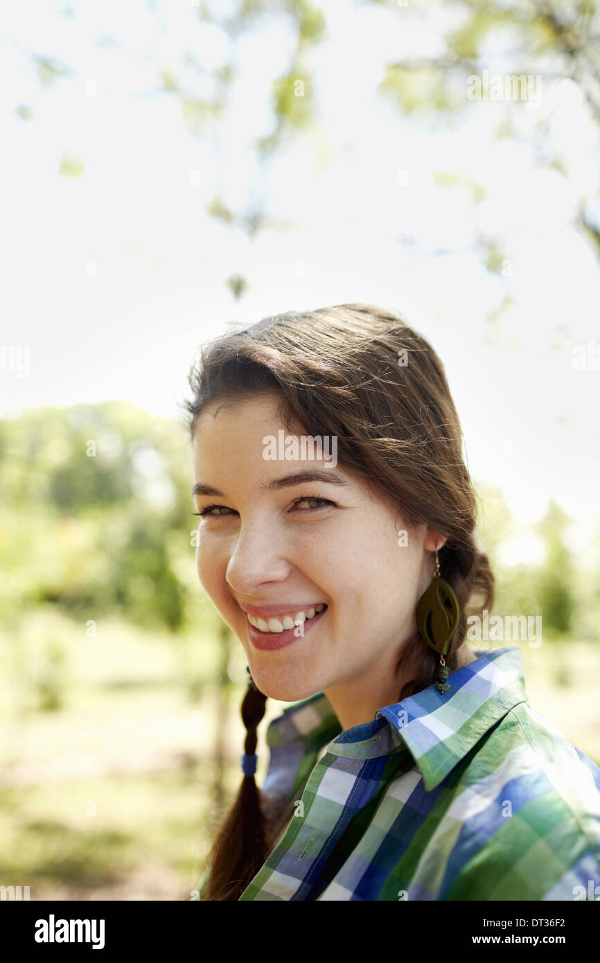 A girl in a green checked shirt with braids Stock Photo