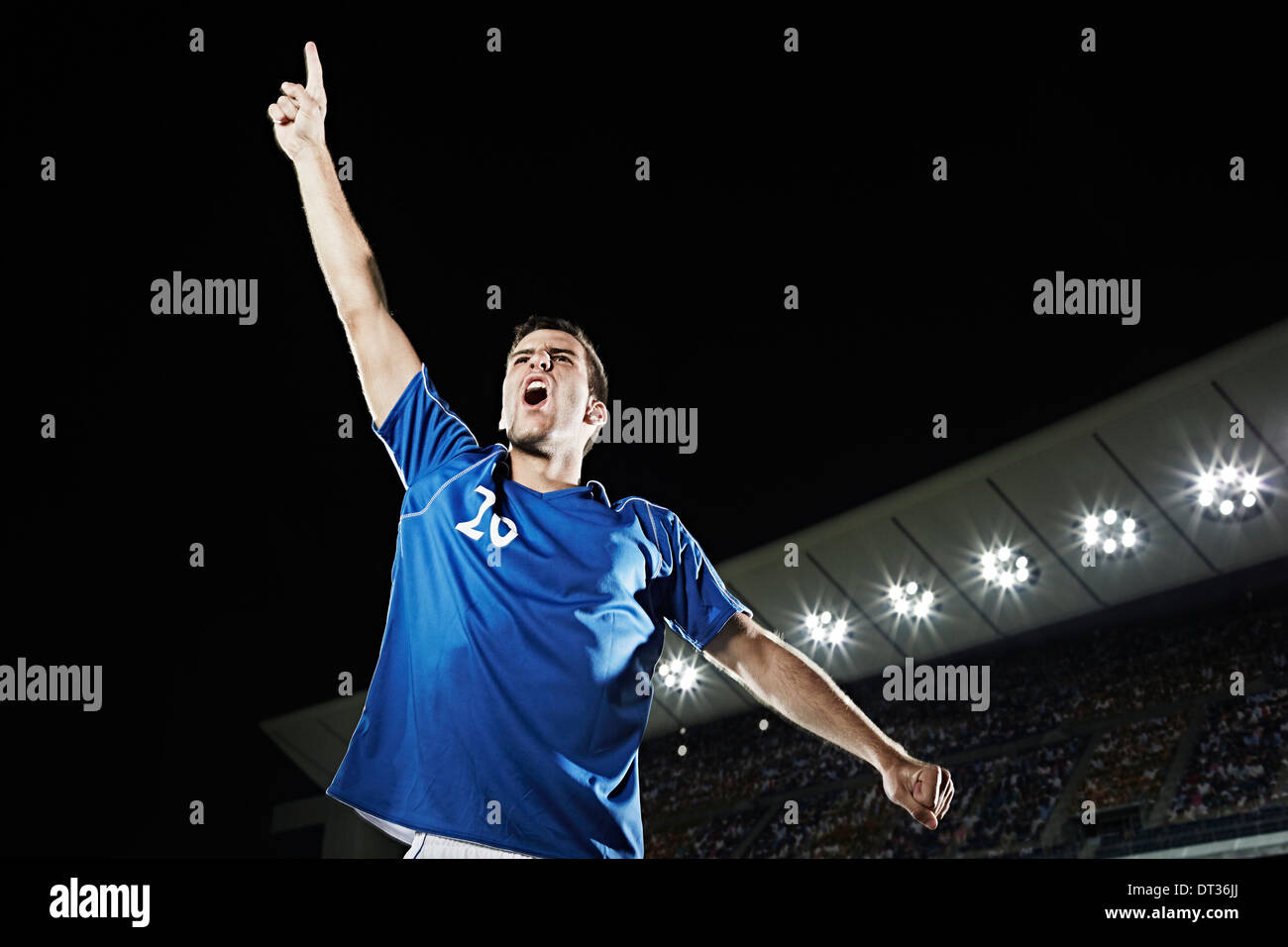 Soccer player cheering in stadium Stock Photo