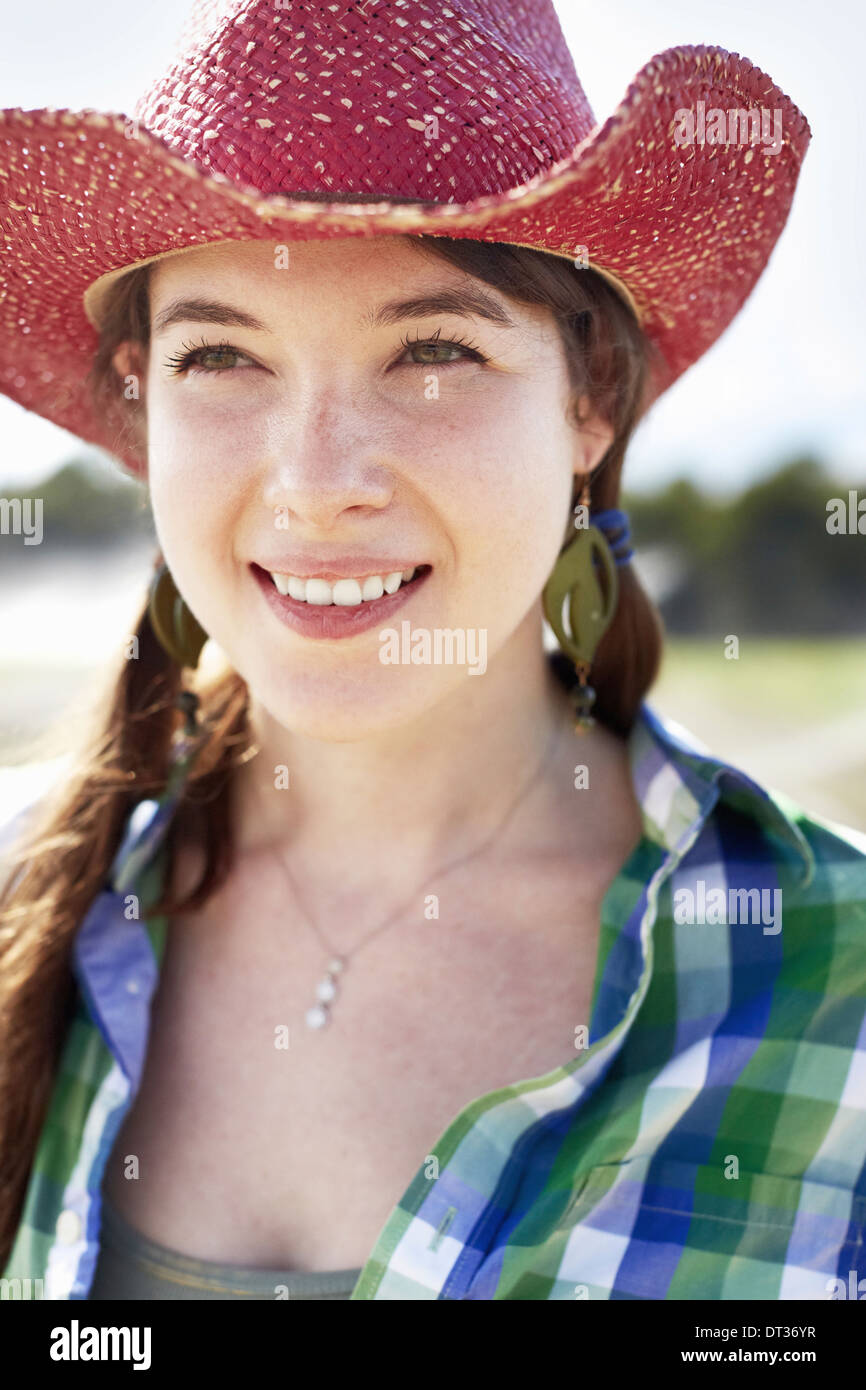 A young woman with braids in a pink wide-brimmed straw hat Stock Photo