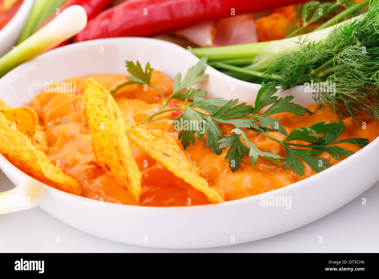 Nachos, cheese sauce, vegetables image Stock Photo Alamy