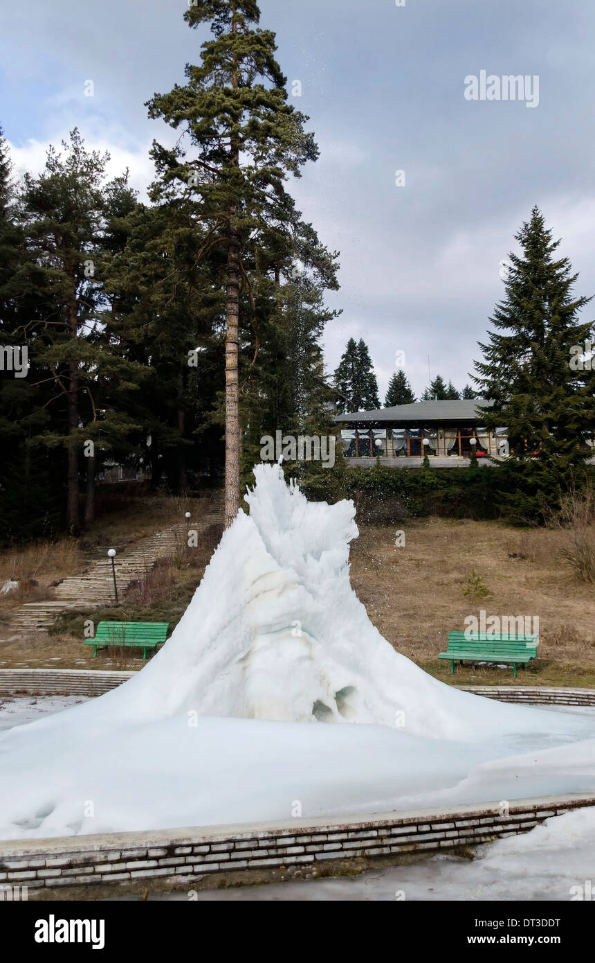 Frozen fountain in mountain in winter, Rila mountain, Borovetz Stock Photo