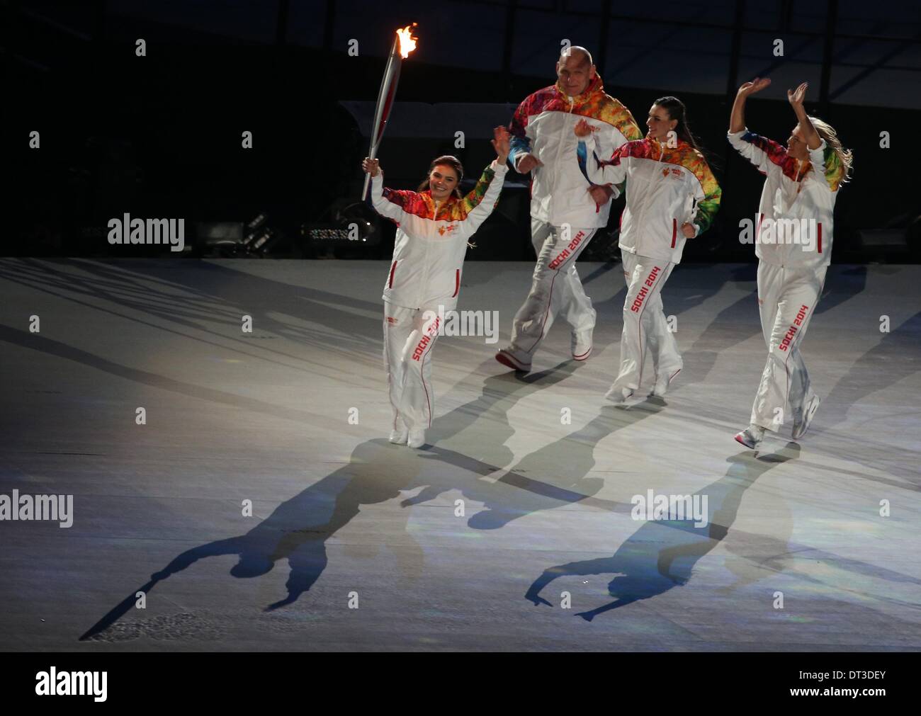 Sochi, Russia. 07 February 2014. Alina Kabaeva (L) of Russia carries the Olympic torch as Alexandr Karelin (2-L), Russian pole vaulter Yelena Isinbayeva (2-R) and tennis player Maria Sharapova of Russia follow during the Opening Ceremony in Fisht Olympic Stadium at the Sochi 2014 Olympic Games, Sochi, Russia, 07 February 2014. Photo: Christian Charisius/dpa in Fisht Olympic Stadium at the Sochi 2014 Olympic Games, Sochi, Russia, 07 February 2014. Photo: Christian Charisius/dpa/Alamy Live News Stock Photo