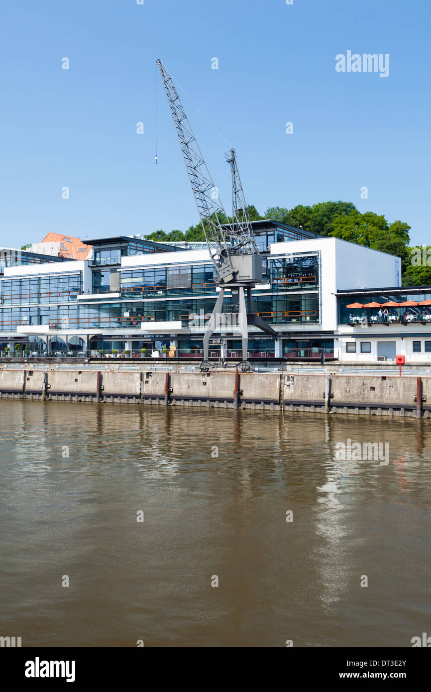 Modern buildings and an old crane in the Fischereihafen (fishing harbor) in Hamburg, Germany at the Elbe River. Stock Photo