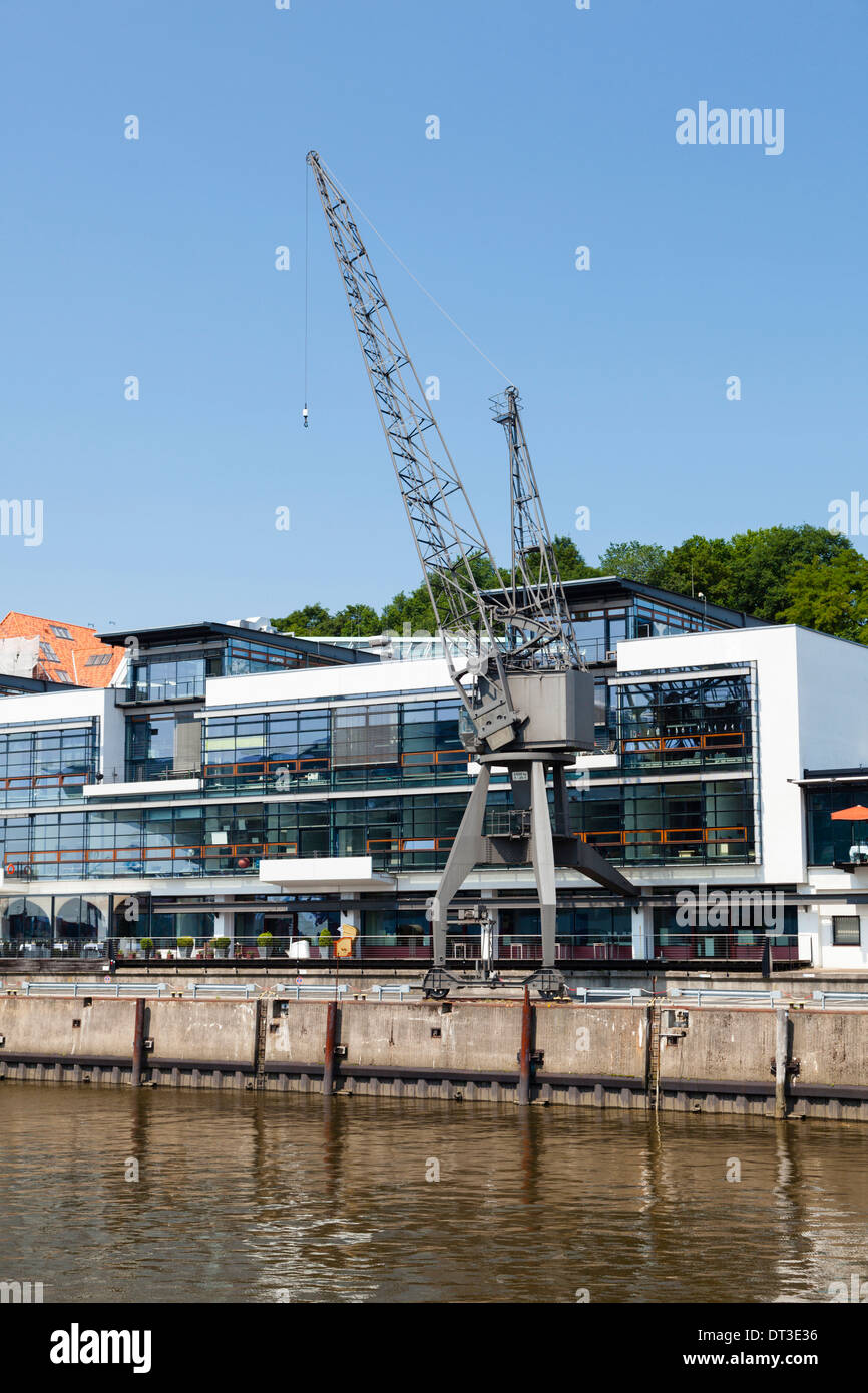 Modern buildings and an old crane in the Fischereihafen (fishing harbor