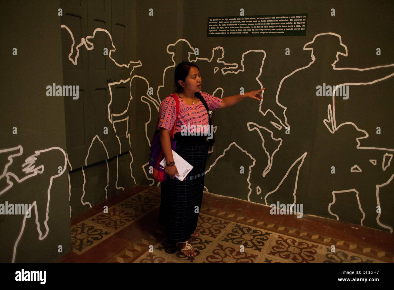 Guatemala City, Guatemala. 7th Feb, 2014. A woman looks at a mural that represents soldiers of the army attacking civilians during the internal armed conflict in Guatemala (1960-1996), which left 200,000 victims, at 'Kaji Tulam' Museum in Guatemala City, capital of Guatemala, on Feb. 7, 2014. The non-governmental organization Center of Legal Action for Human Rights (CALDH, for its acronym in Spanish), opened the museum to contribute to the recovery of historical memory from the Spanish conquest up to the present. © Luis Echeverria/Xinhua/Alamy Live News Stock Photo