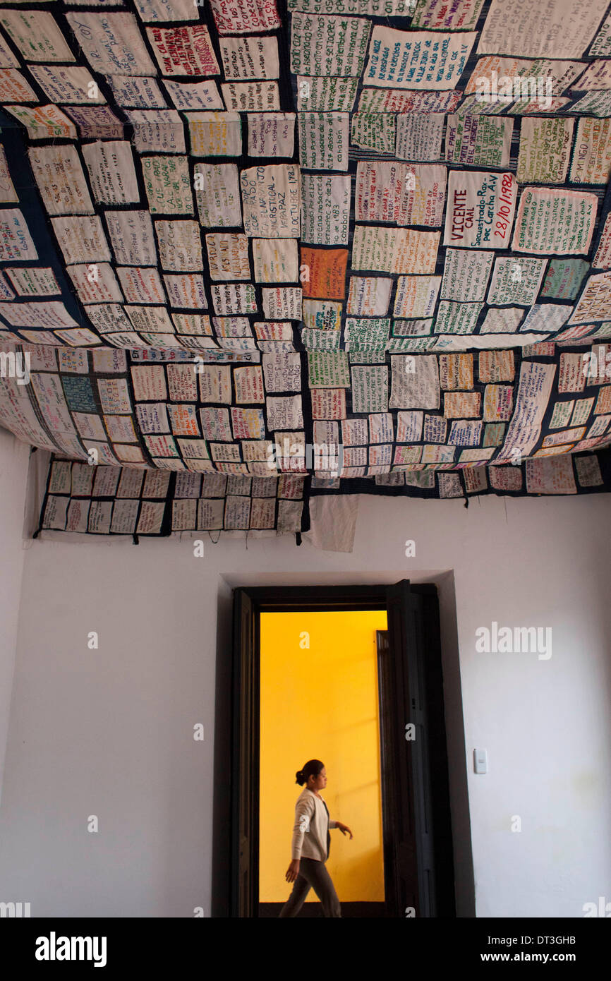 Guatemala City, Guatemala. 7th Feb, 2014. A woman walks below a blanket with names of the internal armed conflict victims in Guatemala (1960-1996), which left 200,000 victims, at 'Kaji Tulam' Museum in Guatemala City, capital of Guatemala, on Feb. 7, 2014. The non-governmental organization Center of Legal Action for Human Rights (CALDH, for its acronym in Spanish), opened the museum to contribute to the recovery of historical memory from the Spanish conquest up to the present. © Luis Echeverria/Xinhua/Alamy Live News Stock Photo