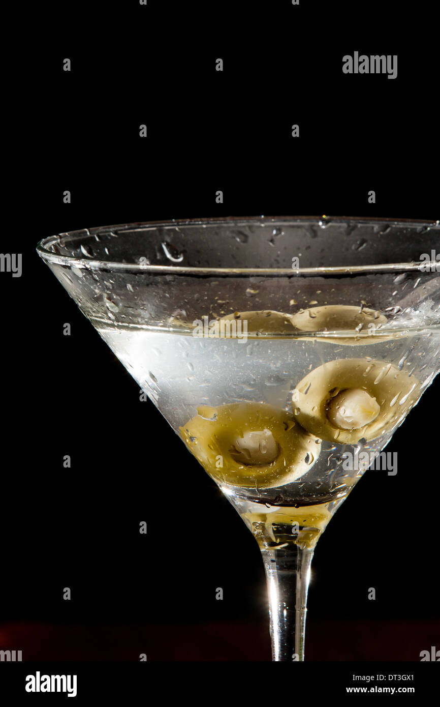 Garlic stuffed martini olives garnishing a sparking vodka martini Stock Photo Alamy