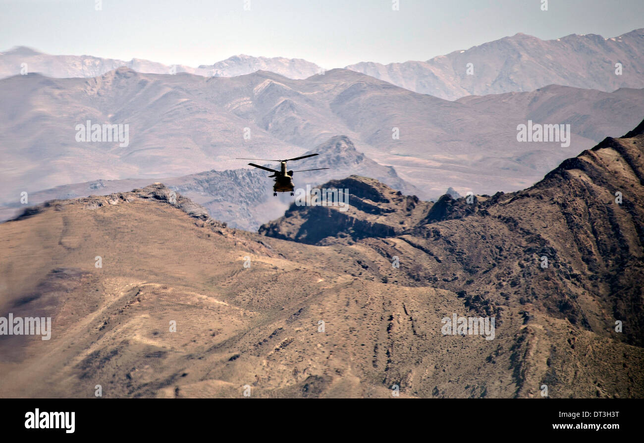 A US Army CH-47F Chinook helicopter flies over western Afghanistan April 12, 2012 on the way to FOB Shindand, Herat province, Afghanistan. Stock Photo