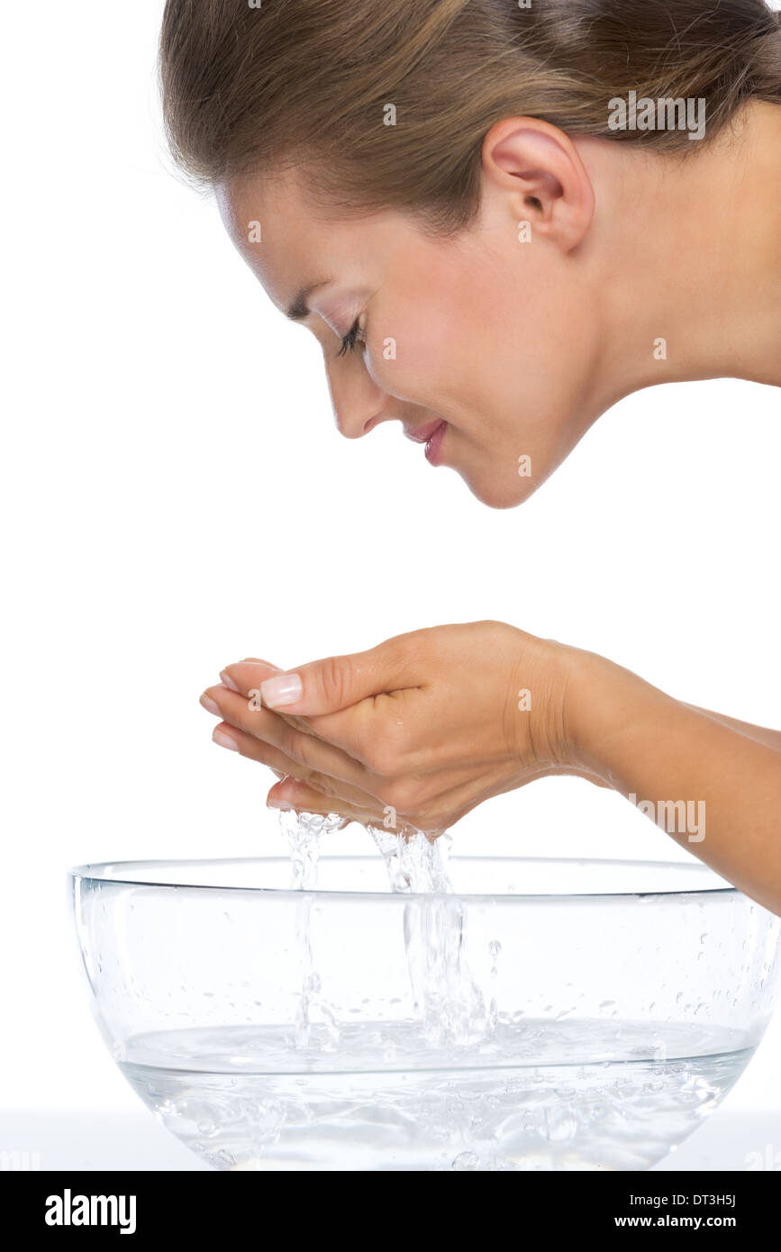 Young woman washing face in glass bowl with water Stock Photo Alamy