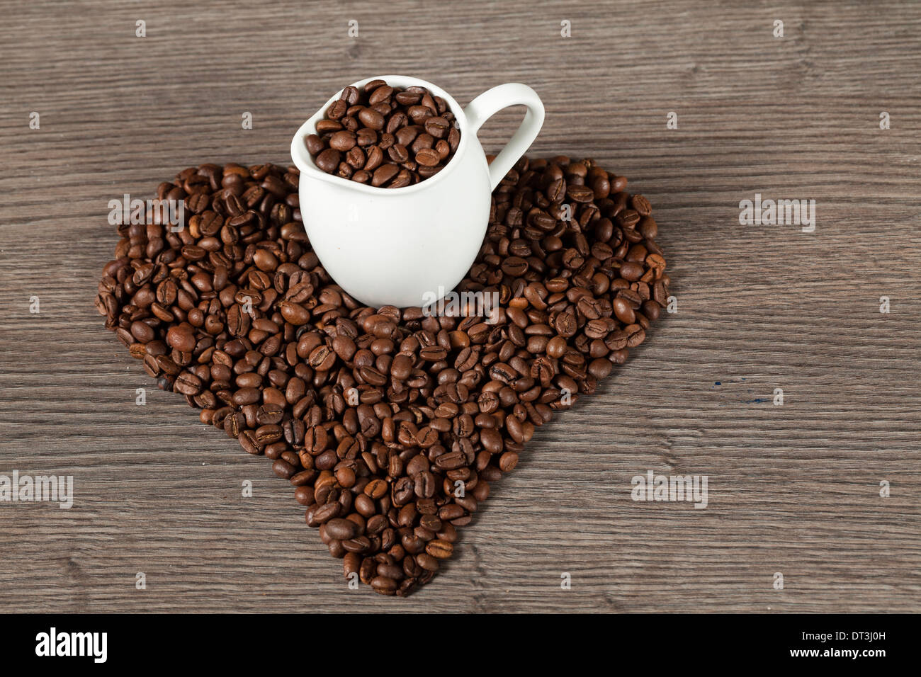 Coffee beans on wooden tale hart shape Stock Photo