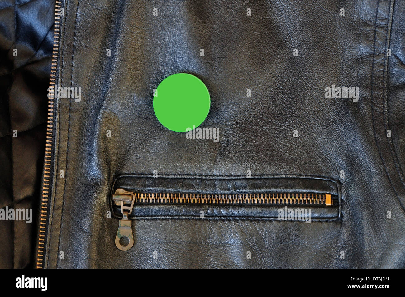 Black leather jacket with zipper and blank pin badge to add your own text or logo. Stock Photo