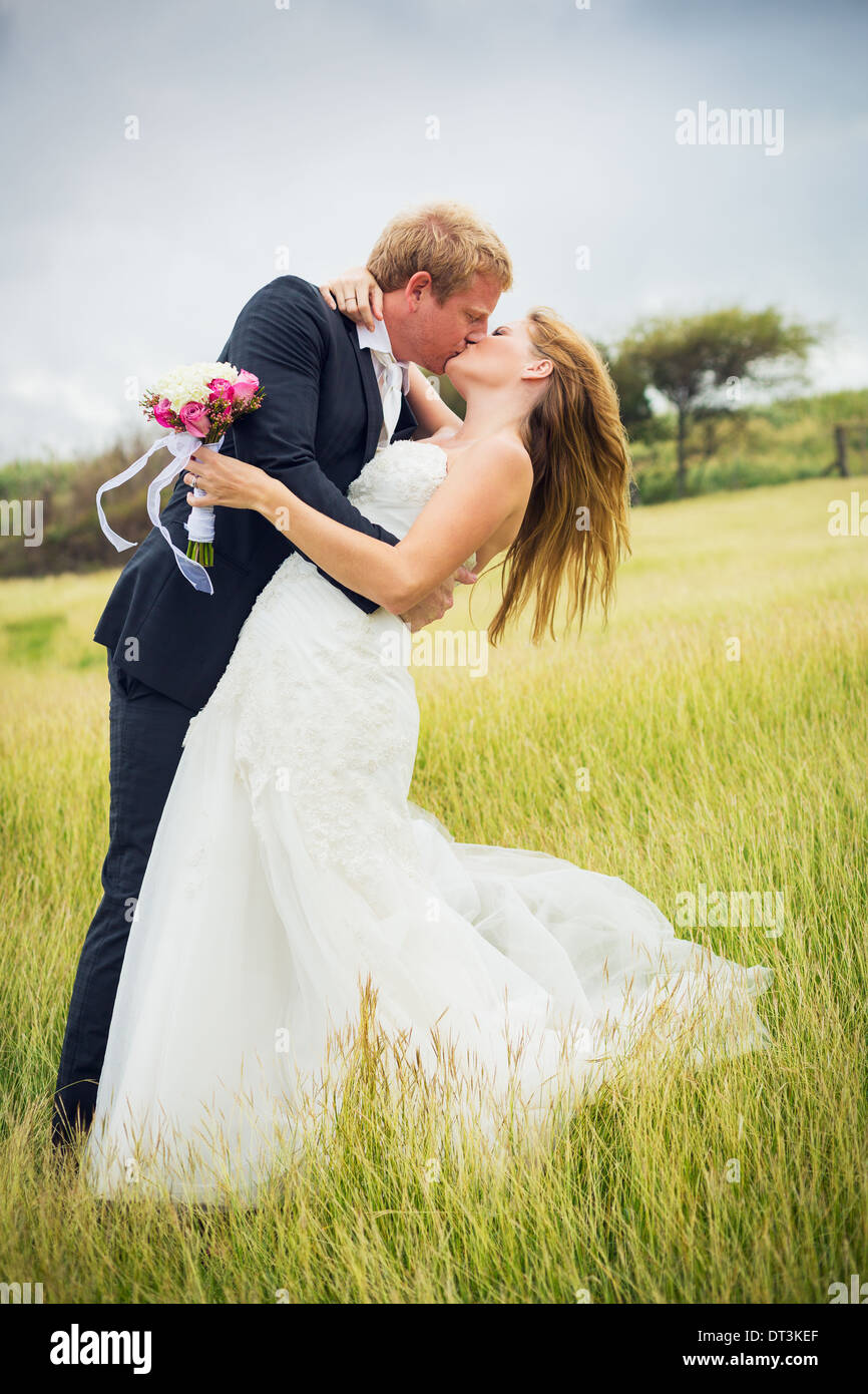Wedding Couple, Happy romantic bride and groom kissing Stock Photo