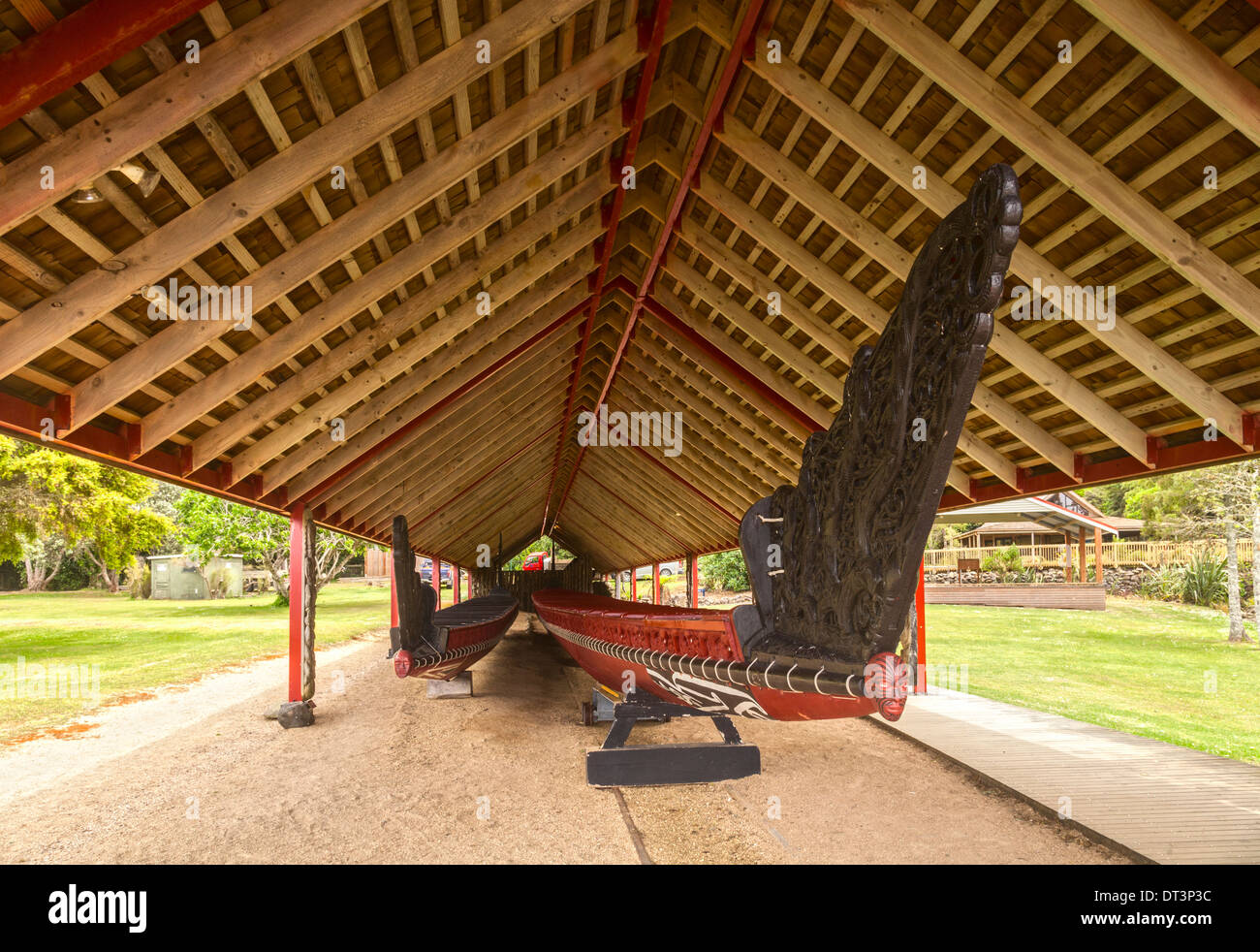 The traditionally styled boathouse on the Waitangi Treaty Grounds, Northland, New Zealand, houses two waka (canoes), including.. Stock Photo