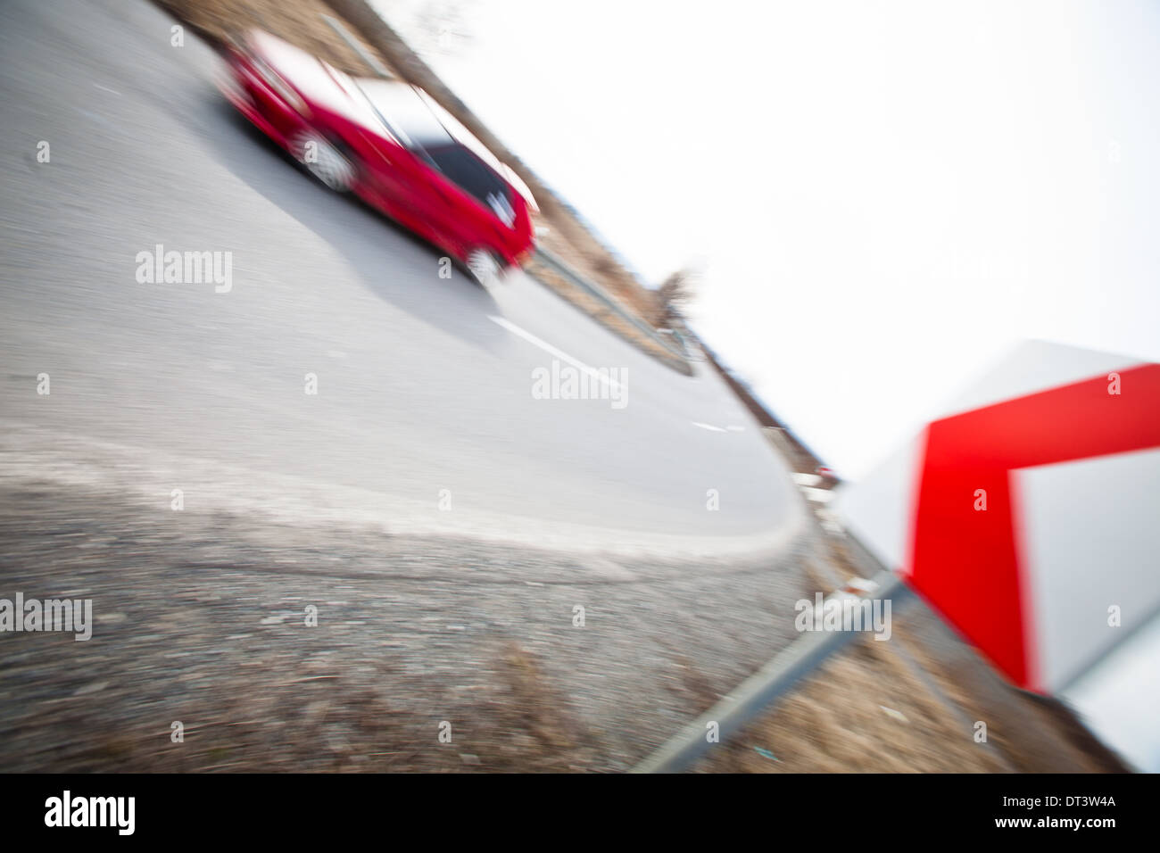 Traffic concept: car driving fast through a sharp turn (motion blur is ...
