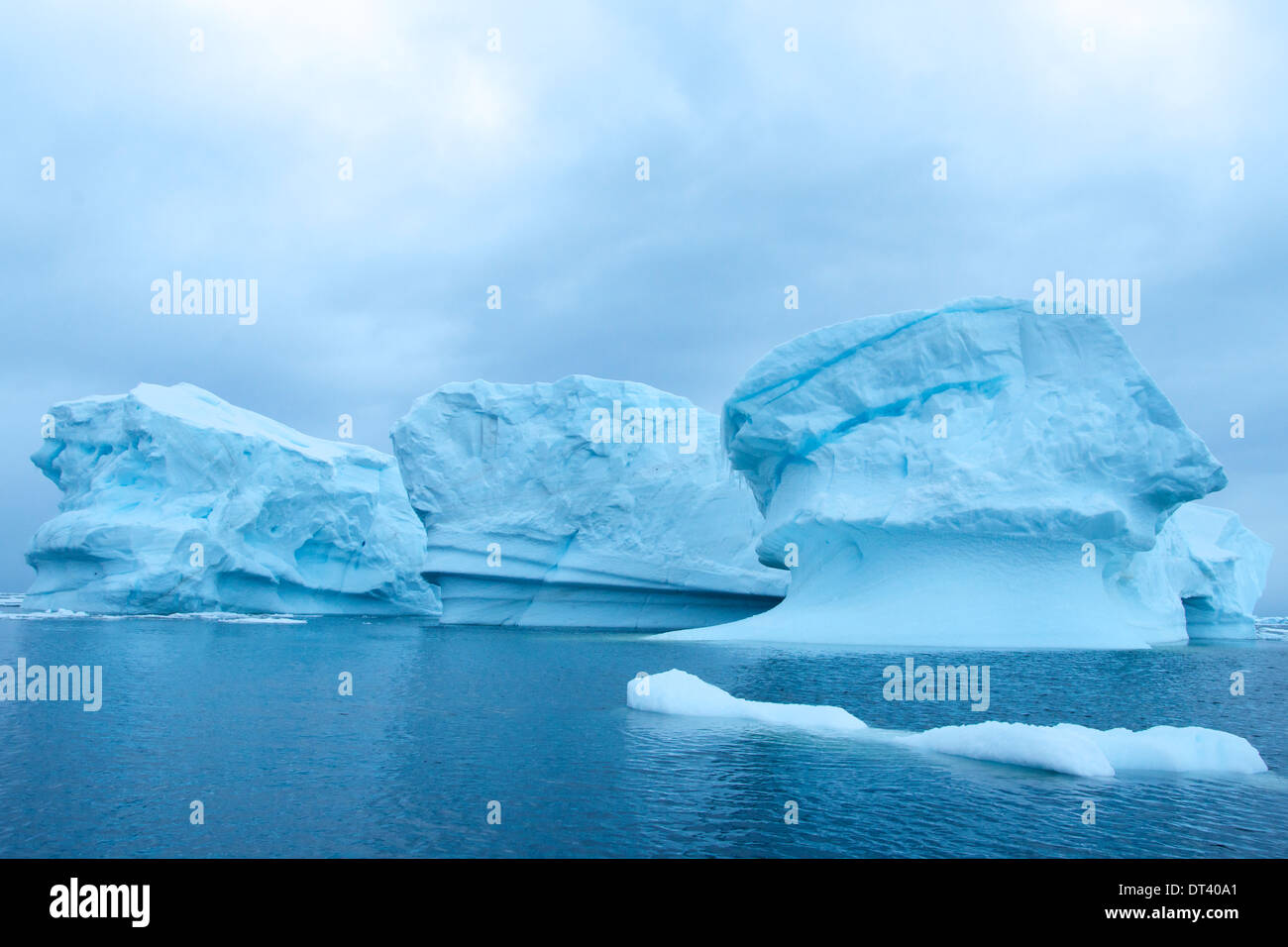 Three strikingly beautiful cobalt blue icebergs in Lemaire Channel, one