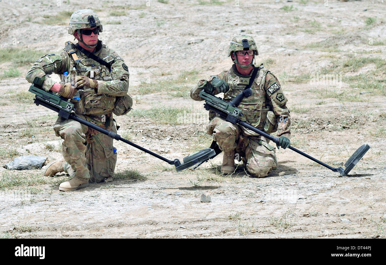 US Army Pfc. Jordan Stom, left, and Pvt. Westley Steedman pause while using mine detectors during Operation Southern Strike II June 4, 2012 near Yaro Kalay, Kandahar province, Afghanistan. Stock Photo